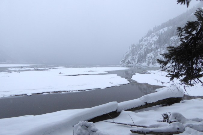 snow covered mud flats and steep mountainside