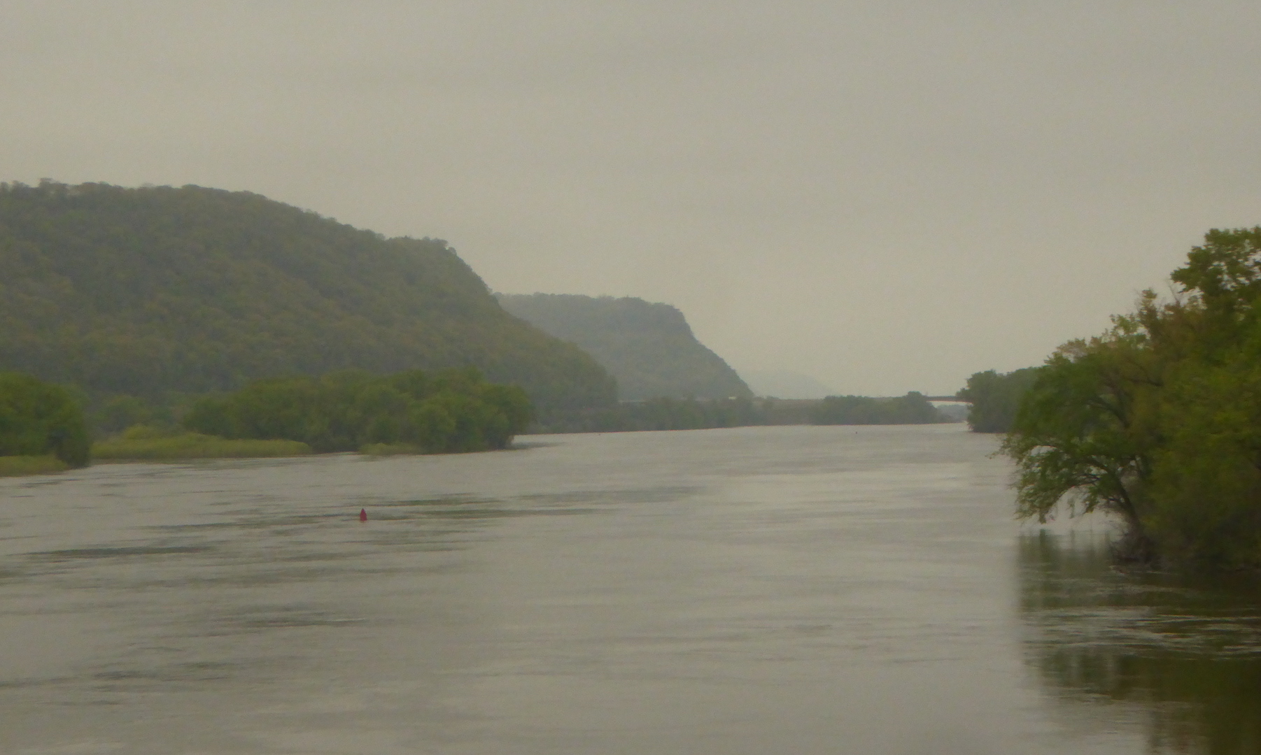 wide river with tall bluffs in background