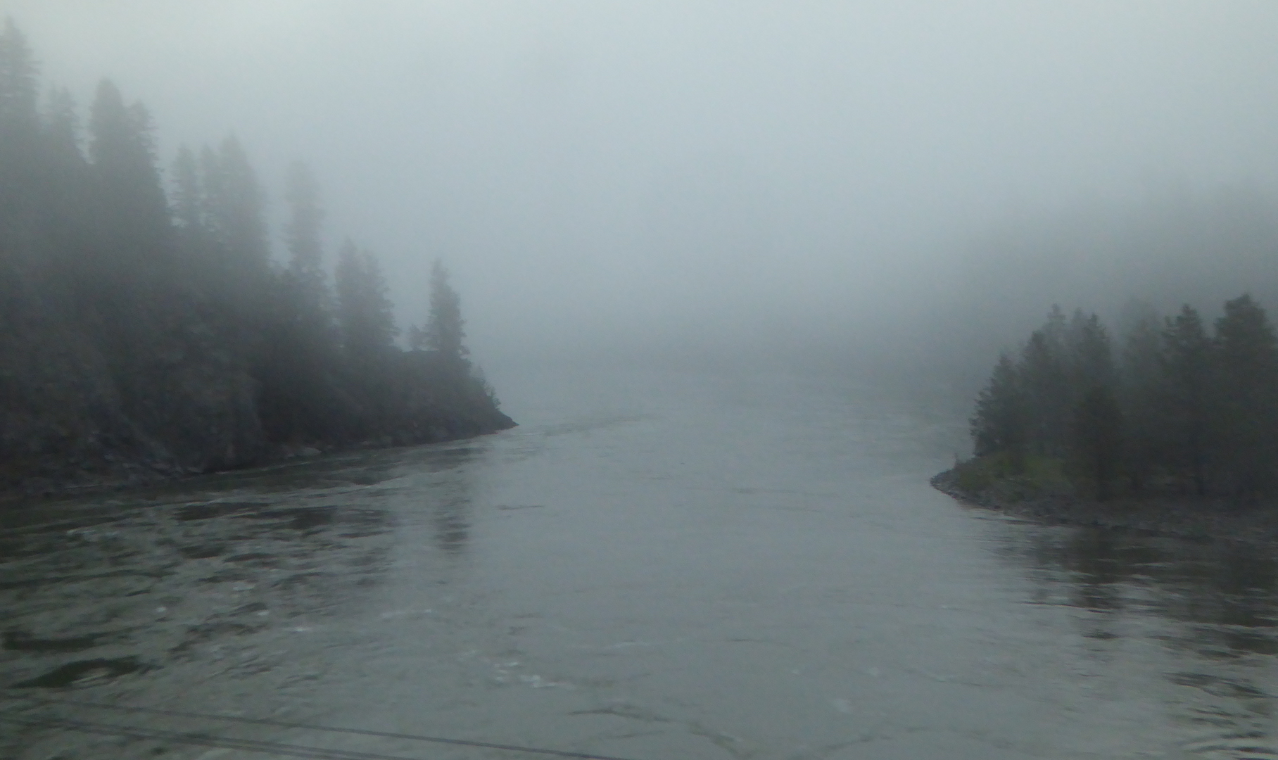 river flowing through foggy valley