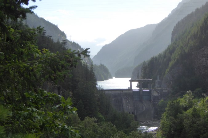 mountain valley with dam and lake