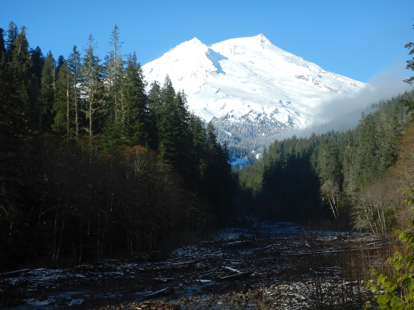 view of snow capped volcano and creek valley