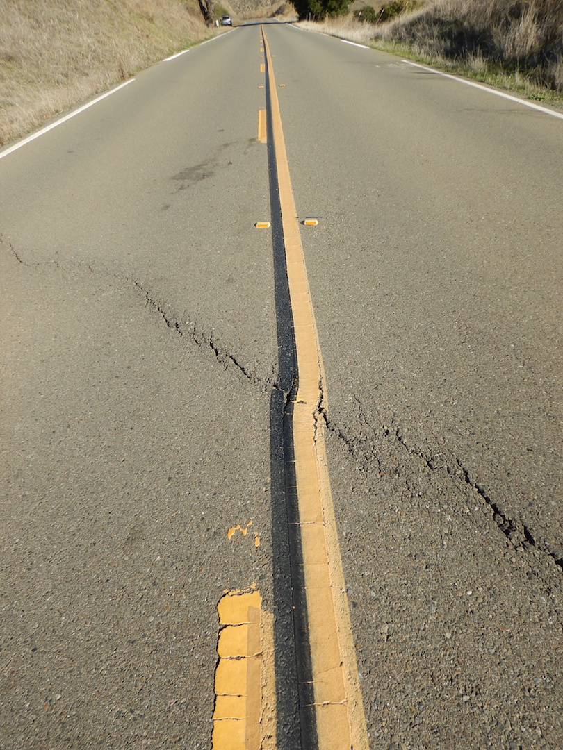 Road with crack running from middle left to lower right.