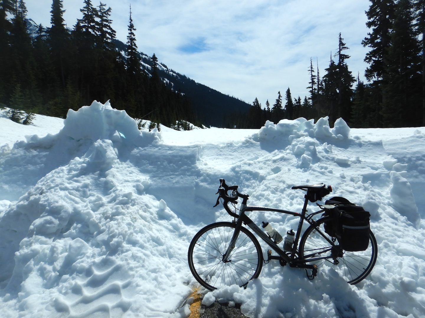 bicycle leaning on five-foot high snow bank