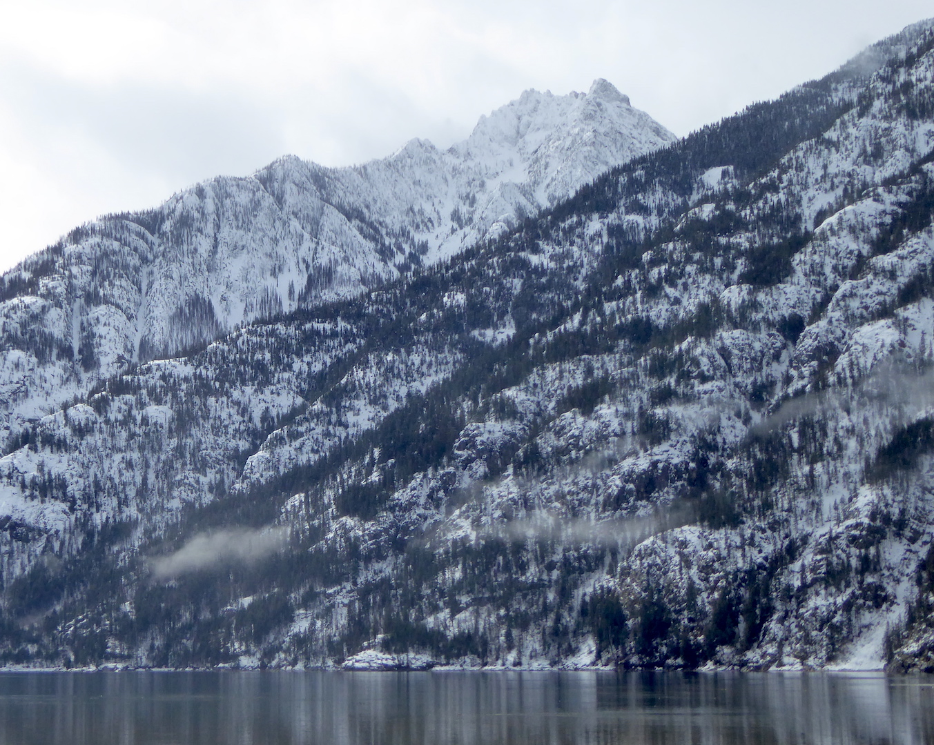 view of snowy mountains rising above lake