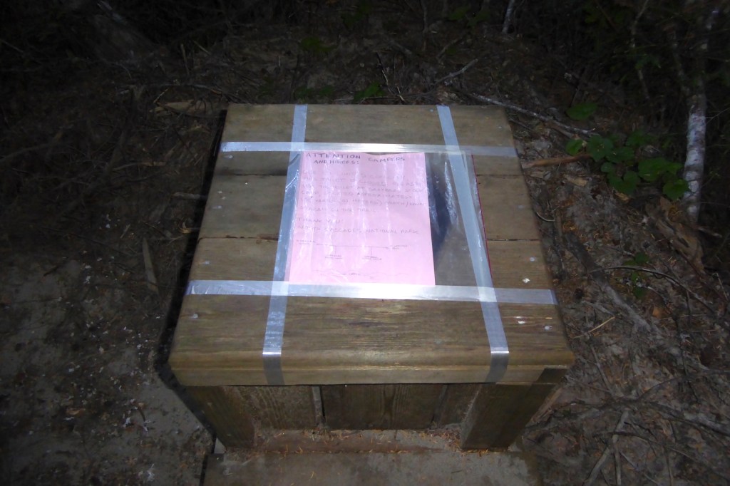 A toilet box with a note taped over the hole.
